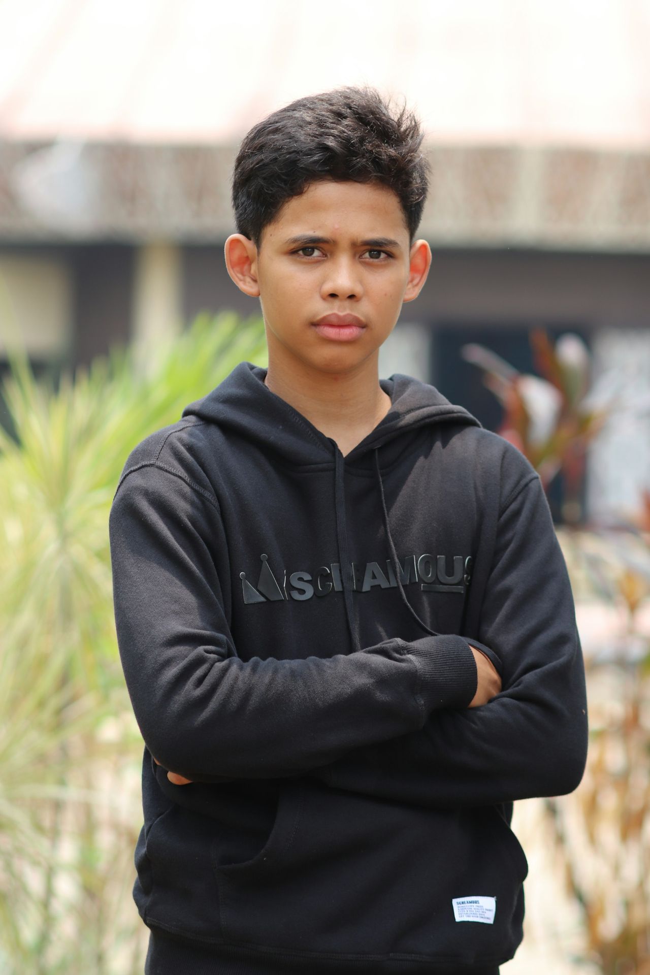man in black zip up jacket standing near green grass during daytime